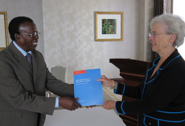 Turner Isoun, Chair of the IAC Panel to Review ASADI, presents the evaluation report to Enriqueta Bond, Chair of the ASADI Board, 10 November 2014, Kampala, Uganda
